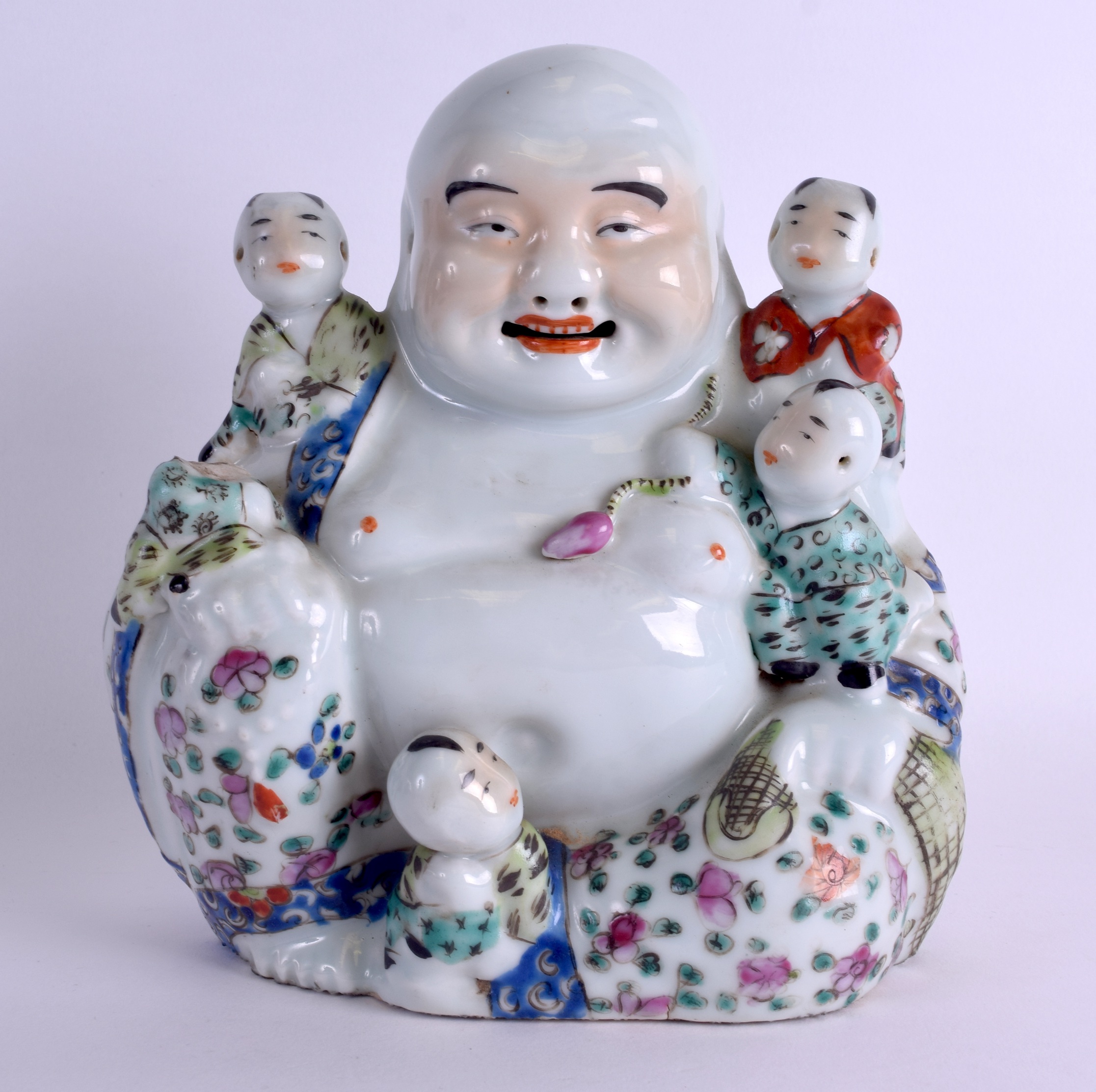 AN EARLY 20TH CENTURY CHINESE FAMILLE ROSE PORCELAIN FIGURE OF A BUDDHA modelled with five