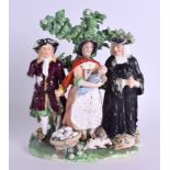AN 18TH CENTURY DERBY TITHE PIG GROUND modelled as a farmer with his wife and another person. 16