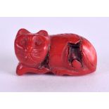 AN EARLY 20TH CENTURY CARVED RED CORAL FIGURE OF A CAT modelled recumbent. 3.25 cm x 1.25 cm.Good