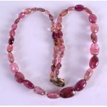 AN EARLY CONTINENTAL CARVED PINK STONE NECKLACE. 38 cm long overall.Fissures