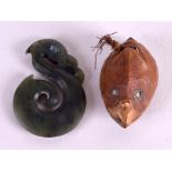 A NEW ZEALAND MAORI NEPHRITE FISH HOOK together with a carved nut tribal head. (2)Good Condition