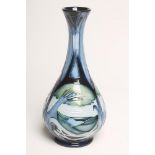 A MOOCROFT POTTERY VASE, 2004, of swept baluster form, tubelined and painted in shades of blue and