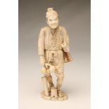 A JAPANESE SECTIONAL IVORY FIGURE, c.1900, as a man wearing a short tunic, a basket slung at his