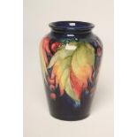 A MOORCROFT POTTERY VASE, mid 20th century, of flared rounded cylindrical form, tubelined and