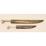 A BALKAN DAGGER, late 19th century, with 9 3/4" curved blade, brass hilt of typical form with two