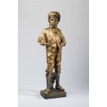 A GOLDSCHEIDER BRONZED EARTHENWARE FIGURE, c.1900, modelled as a young aristocratic boy wearing a