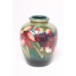 A MOORCROFT POTTERY VASE, mid 20th century, of rounded cylindrical form, tubelined and painted in