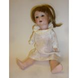 An Armand Marseille bisque head character doll with blue glass sleeping eyes, open mouth and