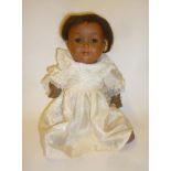 An Armand Marseille bisque head Mulatto girl doll with brown glass sleeping eyes, open mouth and
