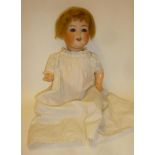 An Ernst Heubach bisque head character doll with blue glass sleeping eyes, open mouth and teeth,