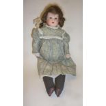 An Ernst Heubach bisque shoulder head doll with blue glass eyes, open mouth, brown mohair wig,