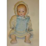 An Armand Marseille bisque head baby doll with blue glass sleeping eyes, closed mouth, moulded hair,