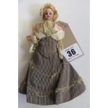 A bisque head and shoulders doll's house doll with fixed brown glass eyes, blonde nylon wig,