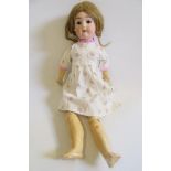 A Max Handwerke bisque head doll, with brown glass sleeping eyes, open mouth and teeth, auburn nylon