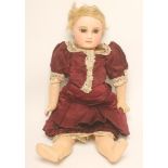 A Jumeau bisque head doll, c.1870, with brown glass fixed almond shaped eyes, closed mouth, blonde