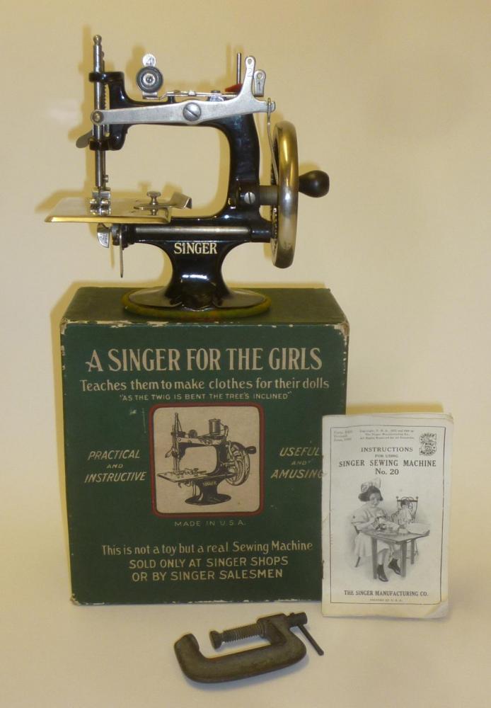 A "Singer for the Girls" sewing machine with japanned cast iron frame, 7" wide, original box with