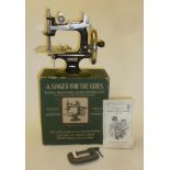 A "Singer for the Girls" sewing machine with japanned cast iron frame, 7" wide, original box with