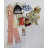 A collection of five china head dolls house dolls with moulded and painted features, one as a needle