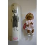 A Sasha doll "Victoria" No.0040214, 11 1/2" high, with spotted pink dress and checked hat, metal and