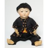 An Armand Marseille Chinese boy doll with bisque head, oriental features, brown sleeping eyes,