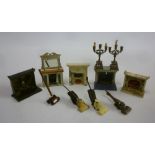 A collection of dolls house furnishings including five metal fireplaces, one with bevelled