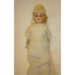 An Ernst Heubach bisque shoulder head doll with fixed brown glass eyes, open mouth and teeth, blonde