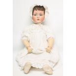 A Kammer & Reinhardt bisque head character doll with blue glass sleeping flirty eyes, open mouth and