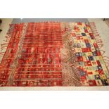 A MOROCCAN BERBER WOOL RUG, with grid, chevron and striped designs in red, navy blue, line green and