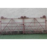 A PAIR OF WROUGHT IRON ENTRANCE GATES, 20th century, of barred form with scrolled surmount, 59" wide