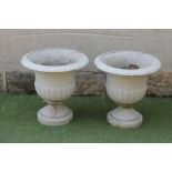 A PAIR OF VICTORIAN TERRACOTTA URNS of half fluted campana form with ovolu moulded rim, waisted