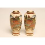 A PAIR OF SATSUMA EARTHENWARE VASES of rounded cylindrical form, painted in typical palette with a