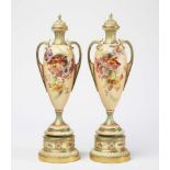 A PAIR OF ROYAL WORCESTER CHINA BLUSH IVORY VASES AND COVERS, 1899, of slender rounded conical