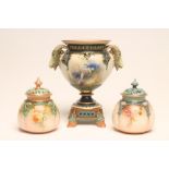 A HADLEY'S WORCESTER CHINA URN, c.1900, of lobed rounded conical form with ram's mask handles,