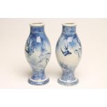 A PAIR OF JAPANESE PORCELAIN VASES of ovoid form on swept pedestals, painted in underglaze blue with