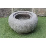 A SMALL GRITSTONE TROUGH of circular tapering form with incurving rim, 17" x 10" (Est. plus 21%