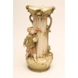 A ROYAL DUX BISQUE PORCELAIN VASE, early 20th century, modelled as a young boy wearing winter