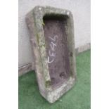 A SANDSTONE TROUGH of rough hewn rounded oblong form, well cut, 36" x 18 1/2" x 8" (Est. plus 21%