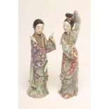 A PAIR OF CHINESE PORCELAIN FIGURES, each modelled as an elegant lady wearing bright enamelled robes