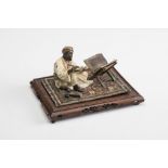 A FRANZ BERGMAN COLD PAINTED BRONZE FIGURE, late 19th century, cast as an Arab scribe seated on a