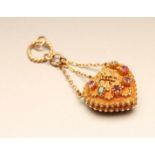 A REGENCY "REGARD" LOCKET, the heart shaped gold pendant set with a ruby, emerald, garnet, amethyst,