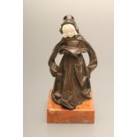 AN ART DECO BRONZE FIGURE, cast as a young girl in a medieval style long dress and flowing mantel,