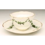 A BRISTOL PORCELAIN SMALL TEABOWL AND SAUCER, c.1780, of lobed form, on-glaze painted in green and