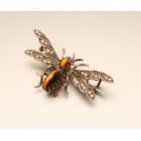 A NOVELTY MOTH BROOCH with polished tiger's eye body and head, ruby eyes and seed pearl set wings to