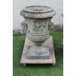 A LARGE COMPOSITION STONE URN of waisted form with scrolled handles, the gadrooned rim over a frieze