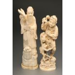 TWO JAPANESE IVORY OKIMONO, Meiji period, one carved as a traveller holding a branch of peaches in