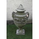 A COMPOSITION STONE URN FINIAL of ovoid form with flower finial on domed lid, floral festoons