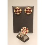 A GARNET AND PEARL CLUSTER RING WITH MATCHING EAR STUDS, the four facet cut circular garnets in