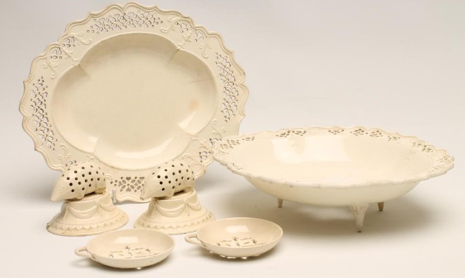A PAIR OF CREAMWARE TOOTHPICK HOLDERS, late 18th century, modelled as hedgehogs on swag moulded