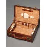 A CROCODILE SKIN TRAVELLING DRESSING CASE, the three glass jars with silver covers, Birmingham 1922,