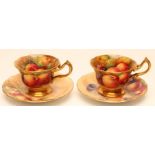 TWO ROYAL WORCESTER CHINA COFFEE CUPS AND SAUCERS, 1935, of lobed circular form with bi-furcated